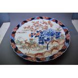 Extremely large 19th century Imari charger with decorative rim and centrally painted with deer among