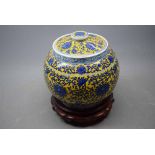 20th century Chinese lidded vase with a yellow ground and blue floral detailing throughout, raised