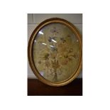 Victorian oval gilt framed silk work panel of a bouquet of flowers, 17ins x 21ins