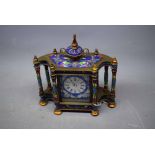 Indian brass and enamel mantel clock with urn style top, enamel Arabic chapter ring, flanked by four