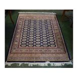 @Modern Bokhara floor rug with blue ground, repeating lozenge centre, multi-gulled border, 190 x 140