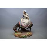 Continental bisque figure of a lady riding a donkey (a/f), 10ins wide x 12ins tall