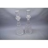 Pair of Waterford cut glass decanters with faceted body and matching stoppers, 13 1/2 ins tall