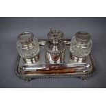 Regency period silver plated ink stand, rectangular shape with gadrooned rim holding two cut glass