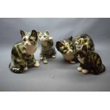 Four assorted Winstanley cats of varying sizes and poses, tallest 10ins