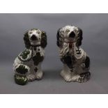 Two 19th century seated Staffordshire dogs, one with a white ground and green lustre ware design and