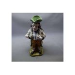 Mosanic French faience Toby Jug modelled as surly gentleman wearing a floral jacket and yellow