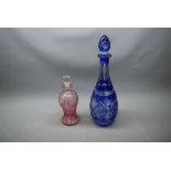 Blue flash cut decanter with matching stopper, together with a further smaller cranberry flash cut