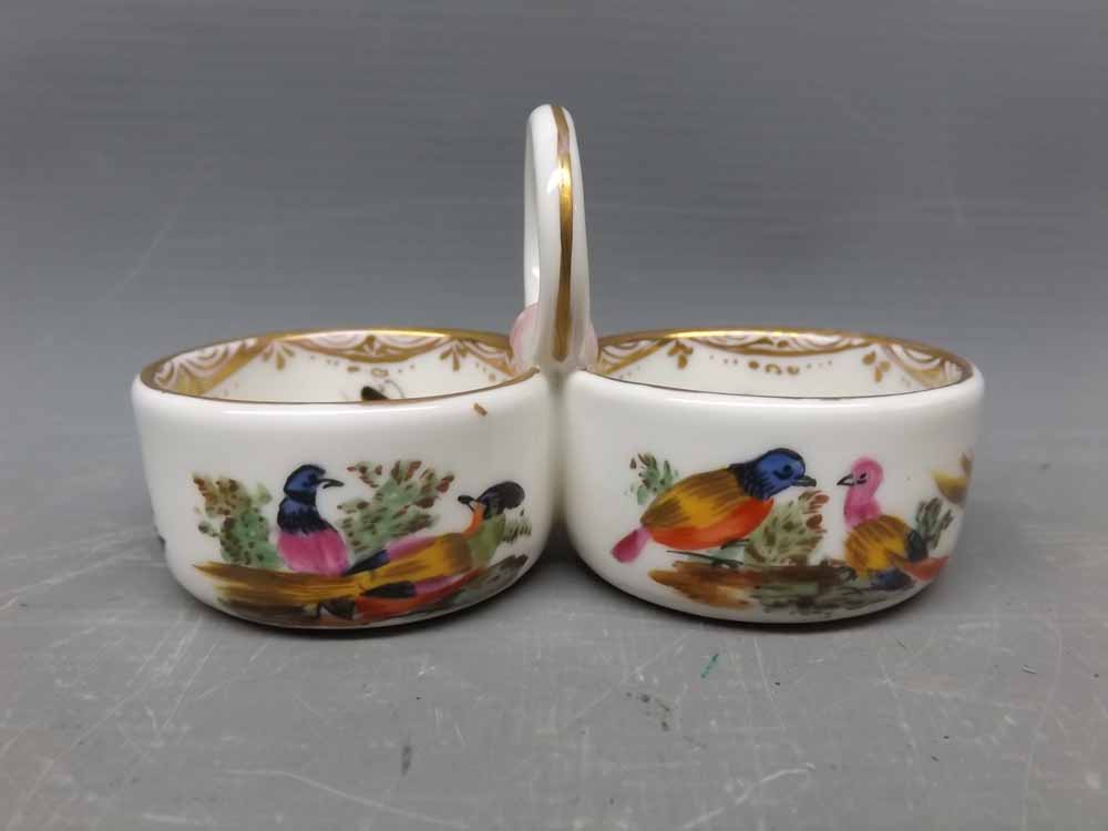 19th century Meissen double salt with looped handle, painted with exotic birds bearing crossed sword