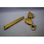 Two miniature vintage brass pulleys together with a further brass square formed five-piece folding