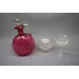Cranberry ewer with clear glass stopper and handle, together with a further cylindrical clear