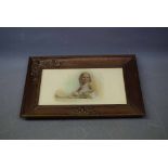 Oak framed photograph of a young girl with a decorative stylised Art Nouveau corner and floral