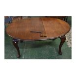 19th century walnut oval extending dining table (with one extra leaf), raised on four pad feet,