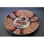 19th century Imari decorated charger with scalloped edge, central floral panel, stylised foliage