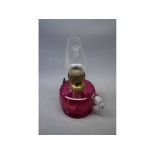 Cranberry peg lamp with clear glass handle, brass mount and clear glass funnel, 10ins tall