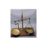 Brass set of scales on a mahogany plinth, 17ins tall