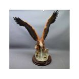 Giuseppe Armani model of an attacking sea eagle on a teak plinth, 19ins tall