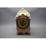 19th century French porcelain mantel clock with decorative gilding and printed floral detail,