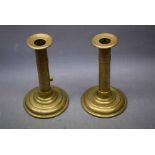 Pair of brass ejector candle sticks with circular stepped bases, 7ins tall