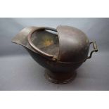 Victorian copper coal helmet with swing handle on circular base, 18ins wide by 13ins tall