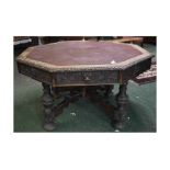 Victorian oak Gothic hexagonal drum table fitted with four drawers with green man carved handles