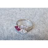 Ruby and diamond platinum cross over ring, London 1976, the pendelsque cut ruby of approx. 0.