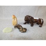 Bronzed model of a lion, a soap stone Fo Dog carving, a jade pendant and a hardstone carving of a