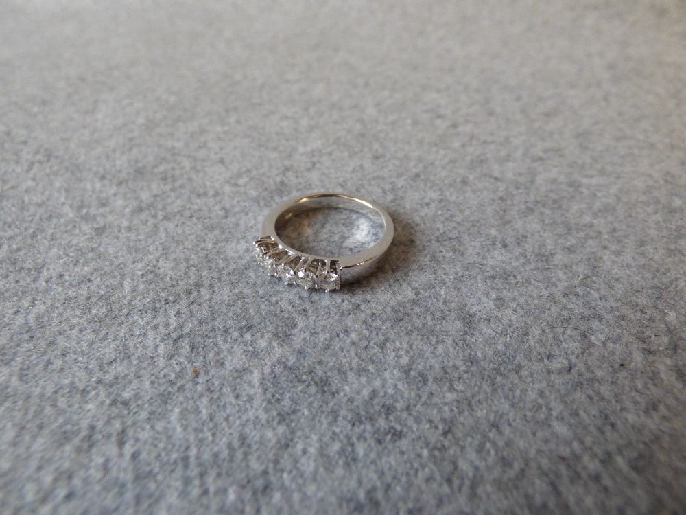 Five stone diamond half hoop ring with white mount stamped '750', uniform brilliant cuts totalling