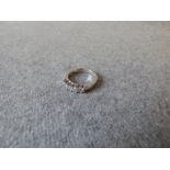 Five stone diamond half hoop ring with white mount stamped '750', uniform brilliant cuts totalling