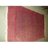 Large burgandy ground rug with geometric patterns