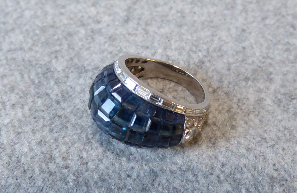 Sapphire and diamond Bombe cluster ring, the head with invisible set sapphires, with a border of