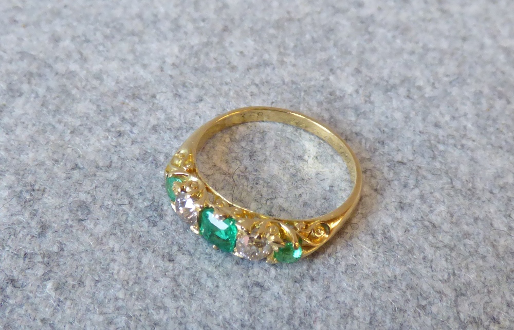 Late Victorian emerald and diamond five stone ring, the graduated emeralds with two old cut