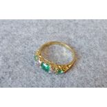 Late Victorian emerald and diamond five stone ring, the graduated emeralds with two old cut