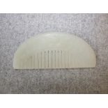 Chinese pale jade comb of demi lune form with foliate carving, 10cm L