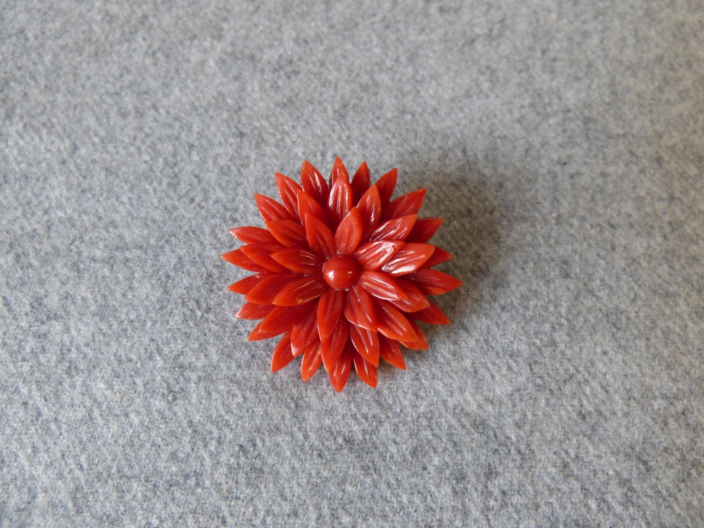 Carved coral flower head brooch, 3.6cm diameter