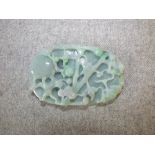 Pale jade carved oval pendant with monkeys in a tree, the base with foliage 18cm L