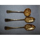 Silver gilt berry spoon and sifting spoons, the two berry spoons and sifting spoon fashioned from