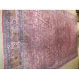 Large Persian design, machine woven, carpet with all over design on maroon ground 303 x 460 cm