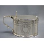 Late Victorian hallmarked silver mustard pot, oval with serpentine sides, bright cut decoration,