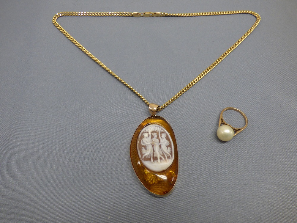 Amber pendant inset with a shell cameo, on a chain stamped '750', pendant tagged '375', chain 8.5g