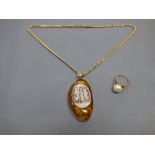 Amber pendant inset with a shell cameo, on a chain stamped '750', pendant tagged '375', chain 8.5g