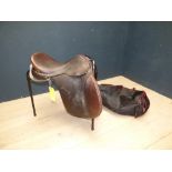Good quality general purpose saddle by 'IDEAL SADDLE CO.' approx. 17" on metal saddle rack & cover