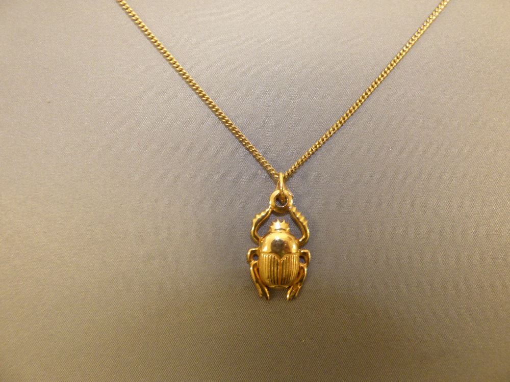 Egyptian Scarab beetle pendant, marked to the bale, 5g gross, on a 9ct gold chain, 5g gross PLEASE