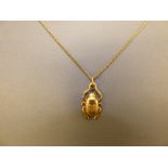 Egyptian Scarab beetle pendant, marked to the bale, 5g gross, on a 9ct gold chain, 5g gross PLEASE