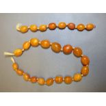 Row of twenty six oval amber beads, 36g gross PLEASE always check condition PRIOR to bidding, or