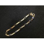 Yellow coloured metal & sapphire chain linked bracelet, marked '750' PLEASE always check condition