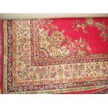 A Persian design machine woven red ground carpet with foliate decoration, 366 x 275 cm PLEASE always