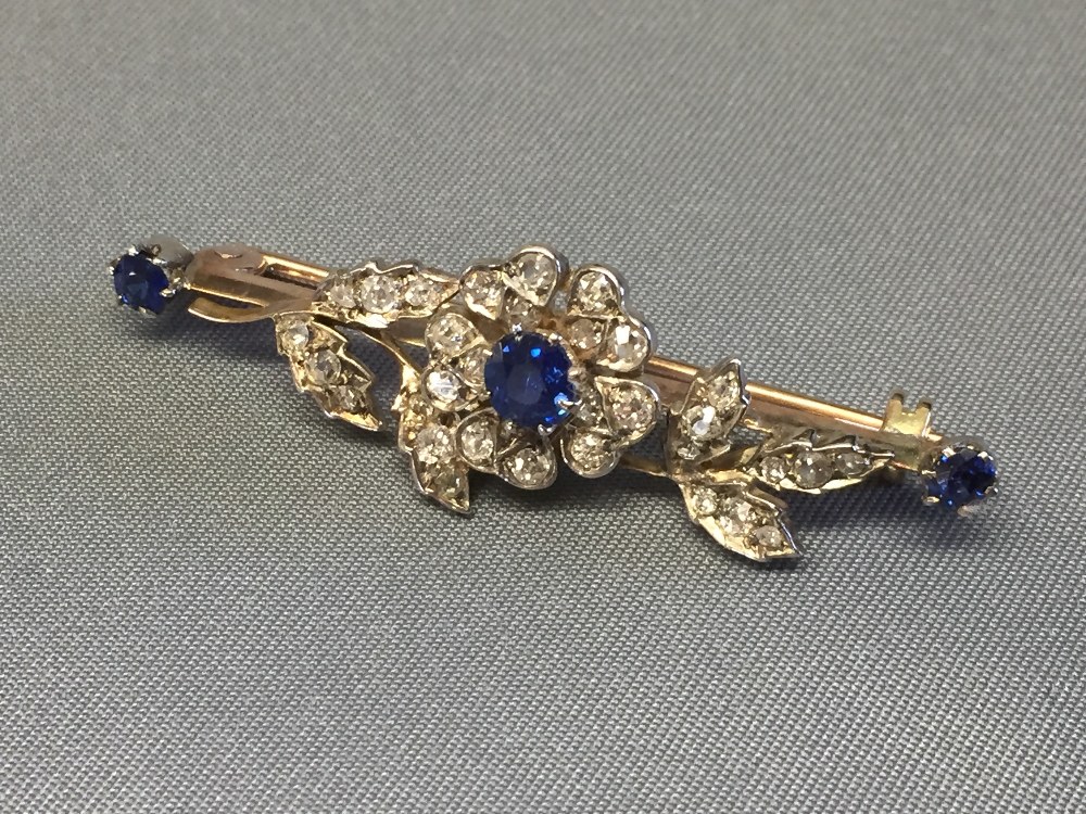 Sapphire and diamond bar brooch, the flower with a central sapphire and small old cut brilliants