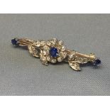 Sapphire and diamond bar brooch, the flower with a central sapphire and small old cut brilliants