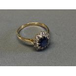 Sapphire and diamond cluster ring, the oval cut sapphire 7.5 x 6.5 mm, enclosed by ten brilliant